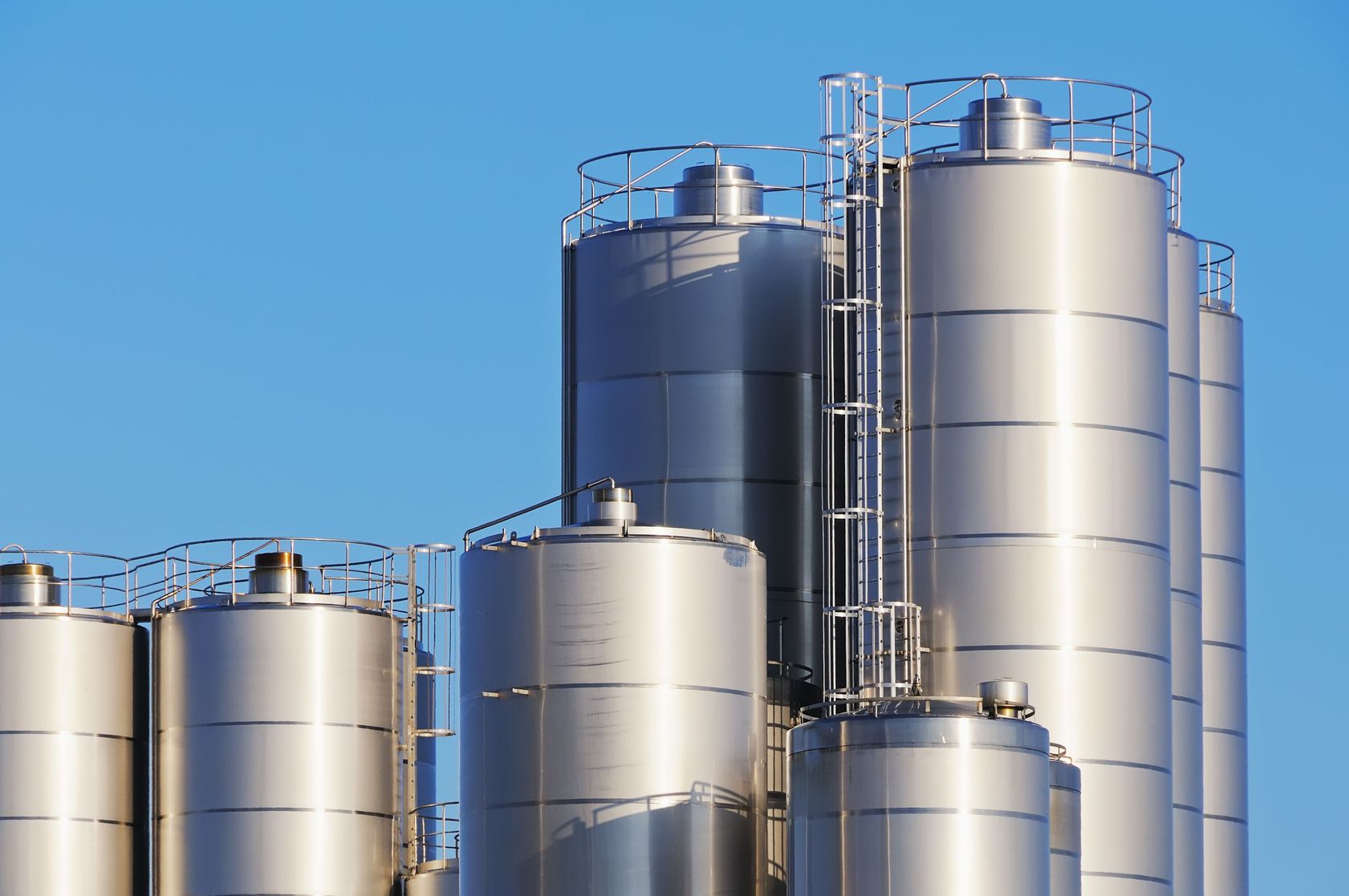 6604435 - close up shot of storage tanks of dairy plant against blue sky.